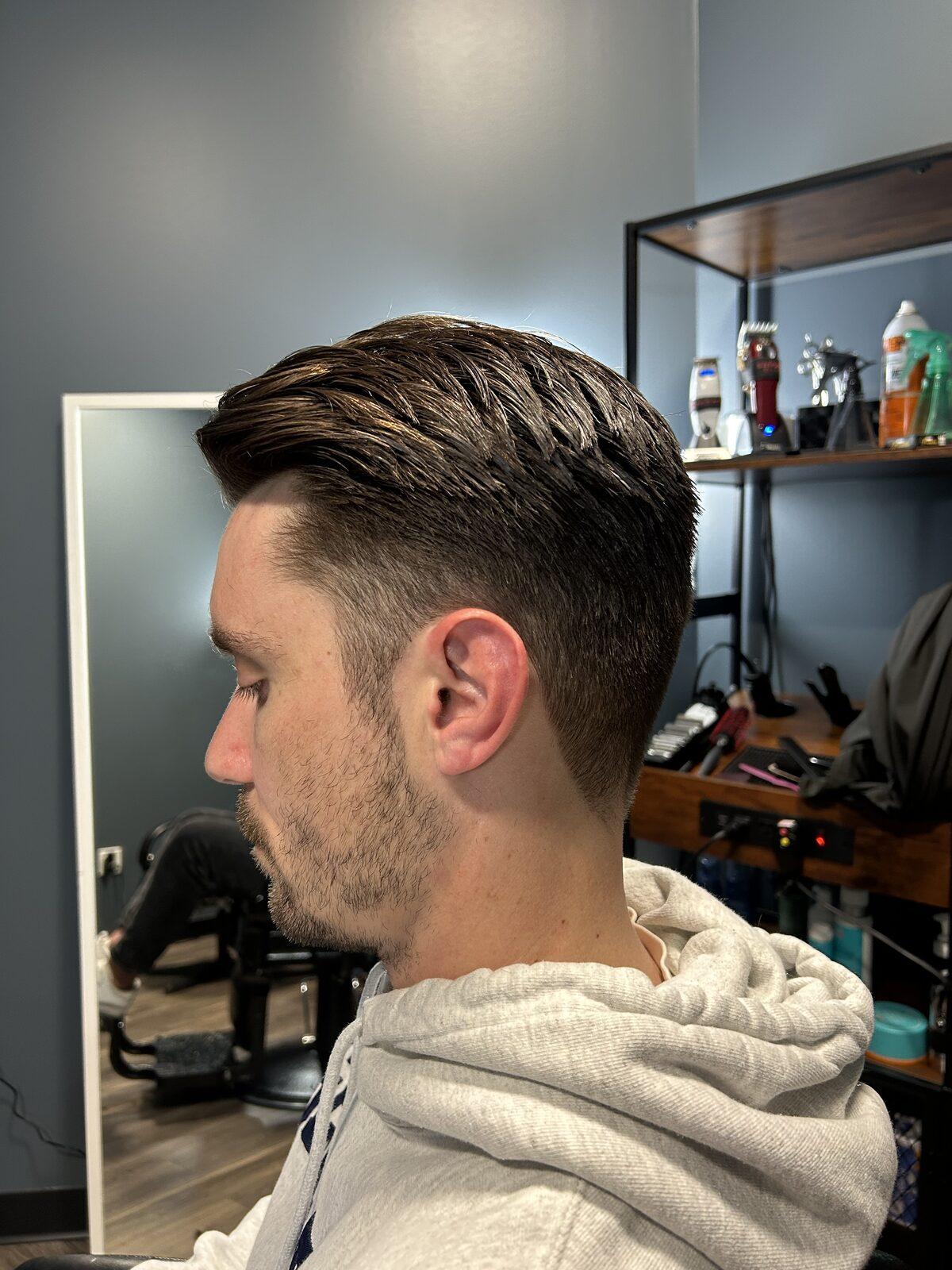 Clean taper styled back with product and a finished fade